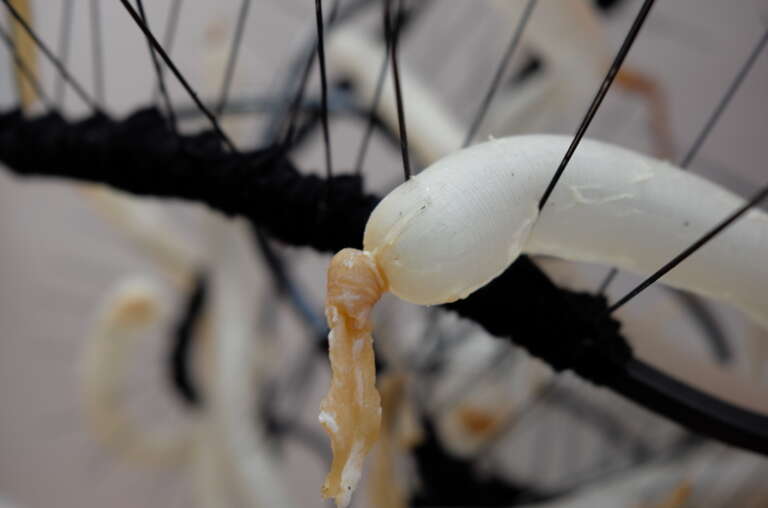 detail of an intertwined sculpture of wires, spikes and intestines.