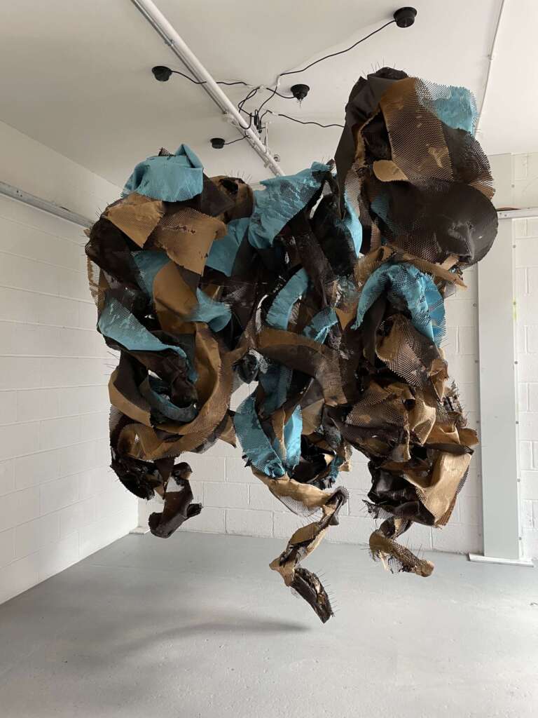 a 5 part large rotating sculpture that is made out of steel and paper. By Tania Salha