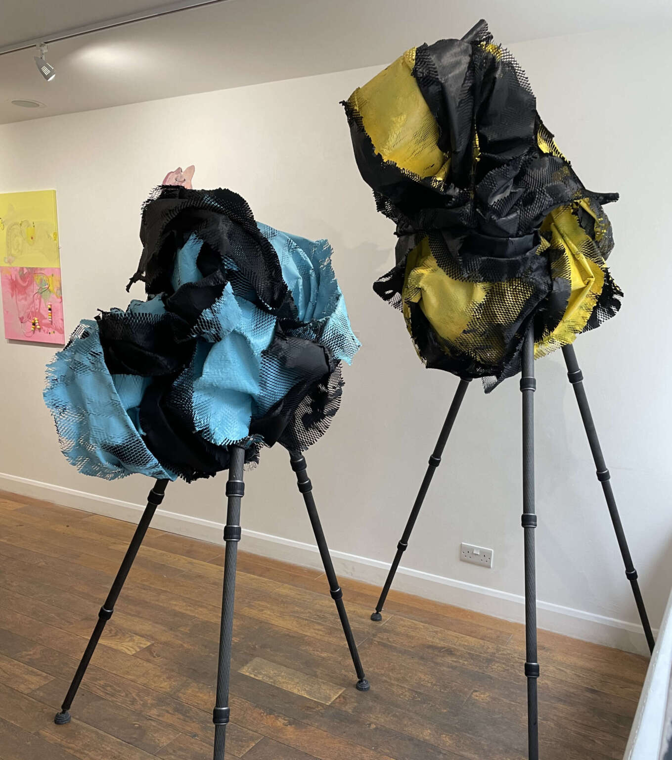 two piece sculpture, blue and yellow paper on tripod