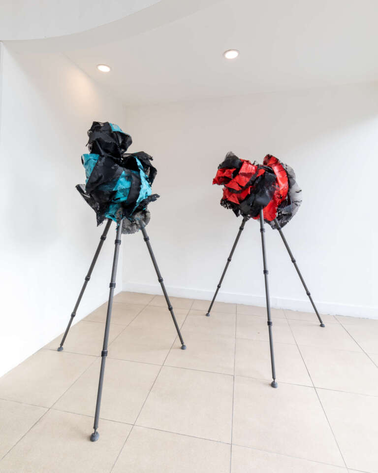 Two pieces sculpture of Blue and red painted paper on tripods at Koppel X gallery